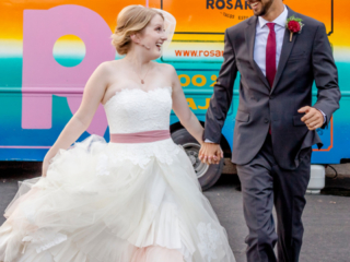 Newlyweds running in front of a food-truck at Sanctuary Event Space